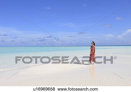 Woman at white sand beach, Maldive Islands View Large Photo Image Stock Photo - Woman at white sand beach, Maldive Islands. Fotosearch