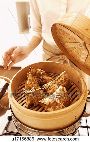 Woman cooking bamboo parcels View Large Photo Image Stock Photograph - Woman cooking bamboo parcels. Fotosearch
