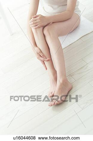 Woman giving herself a leg massage View Large Photo Image Stock Photo - Woman giving herself a leg massage. Fotosearch