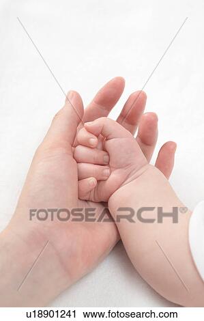Stock Image - Woman holding child's hand. Fotosearch
