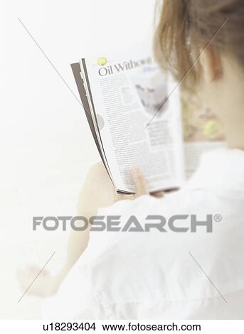 Picture - Woman reading a magazine. Fotosearch
