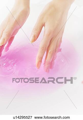 Stock Photo - Woman soaking her hands in bowl of water. Fotosearch