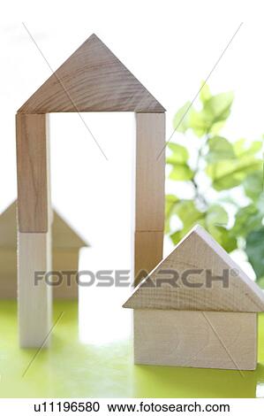 Stock Image - Wooden blocks stacked in house and arch shapes. Fotosearch