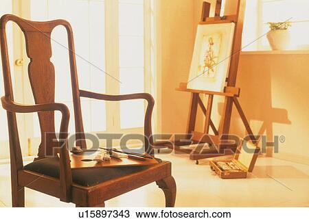 Wooden Chair And Oil Painting On Easel Stock Image U15897343