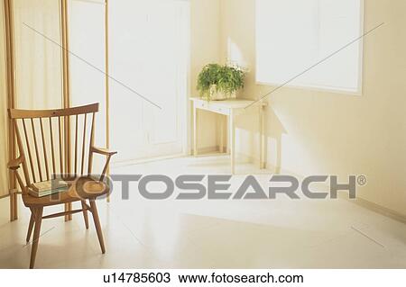 Wooden chair in sunny room with pot plant View Large Photo Image Stock Image - Wooden chair in sunny room with pot plant. Fotosearch