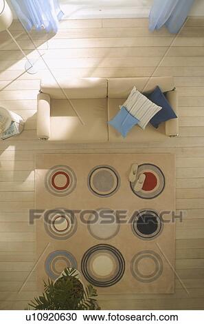 Wooden floored room with sofa and rug View Large Photo Image Stock Image - Wooden floored room with sofa and rug. Fotosearch