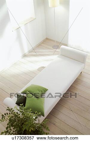 Stock Photo - Wooden floored room with white chaise longue. Fotosearch