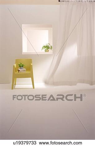 Stock Image - Yellow chair with pot plants in modern room. Fotosearch