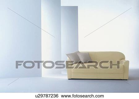 Stock Photograph - Yellow sofa in room with white walls. Fotosearch