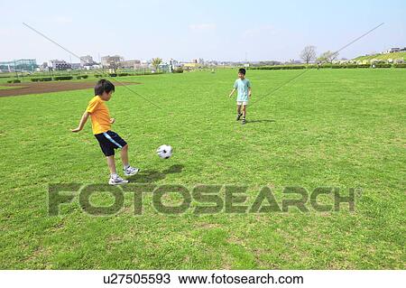Young boys playing soccer on field. Futako-tamagawa, Setagaya-ku, Tokyo Prefecture, Japan View Large Photo Image Stock Image - Young boys playing soccer on field. Futako-tamagawa, Setagaya-ku, Tokyo Prefecture, Japan. Fotosearch