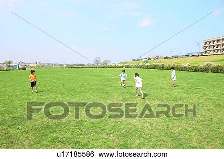 Young boys playing soccer on field. Futako-tamagawa, Setagaya-ku, Tokyo Prefecture, Japan View Large Photo Image Stock Photograph - Young boys playing soccer on field. Futako-tamagawa, Setagaya-ku, Tokyo Prefecture, Japan. Fotosearch