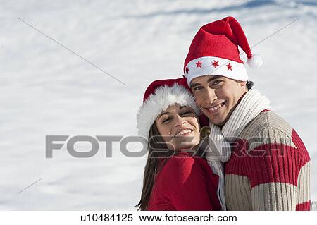 Couple in Christmas outfit embracing View Large Photo Image Stock Photography - Couple in Christmas outfit embracing. Fotosearch