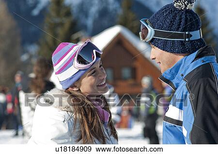 Stock Photo - Couple outside of ski lodge. Fotosearch