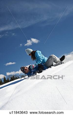 Stock Image - Couple playing with snow. Fotosearch