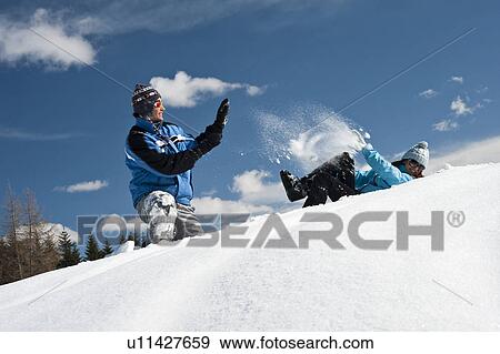 Couple playing with snow View Large Photo Image Stock Photo - Couple playing with snow. Fotosearch