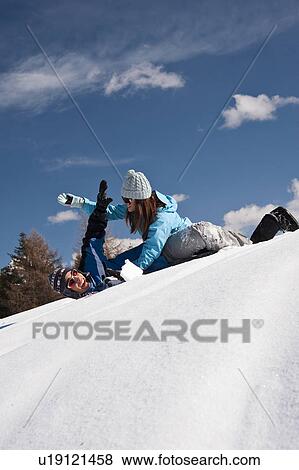 Stock Photo - Couple playing with snow. Fotosearch
