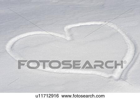 Stock Photograph - Heart shape in snow. Fotosearch