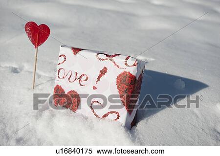 Present and lollipop with hearts in the snow View Large Photo Image Stock Photography - Present and lollipop with hearts in the snow. Fotosearch