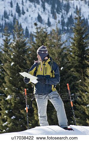 Stock Image - Young man in snow hiking. Fotosearch