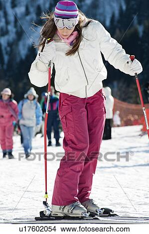 Picture - Young woman in snow with skis. Fotosearch