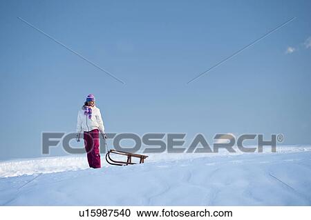 Young woman in snow with sleigh View Large Photo Image Stock Image - Young woman in snow with sleigh. Fotosearch