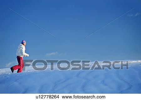 Young woman running in snow View Large Photo Image Picture - Young woman running in snow. Fotosearch