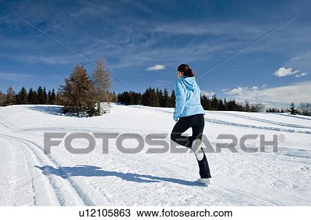 Young woman running in snow View Large Photo Image Stock Image - Young woman running in snow. Fotosearch