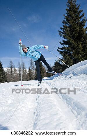 Stock Image - Young woman skiing. Fotosearch