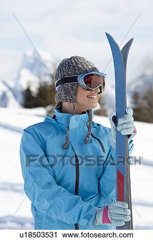 Stock Image - Young woman with skis and ski shades. Fotosearch