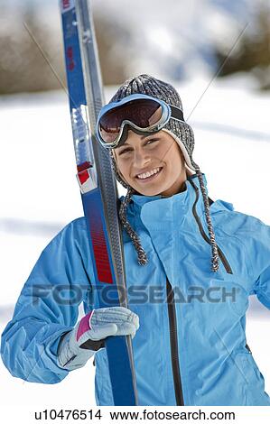 Picture - Young woman with skis. Fotosearch