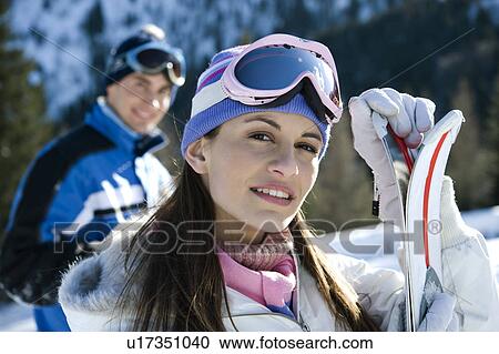 Young woman with skis View Large Photo Image Stock Image - Young woman with skis. Fotosearch