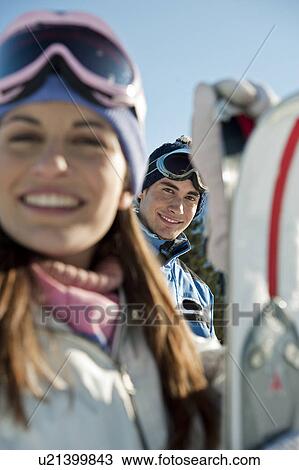 Stock Image - Young woman with skis. Fotosearch