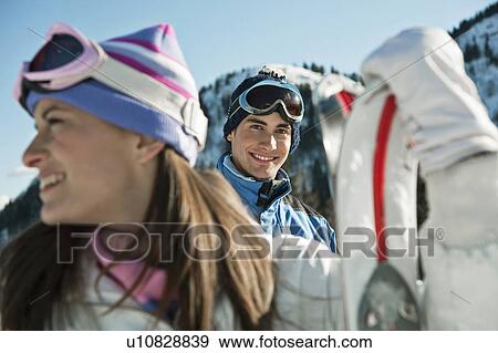Stock Photo - Young woman with skis. Fotosearch
