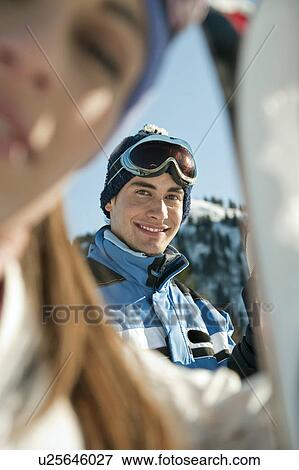 Stock Photo - Young woman with skis. Fotosearch