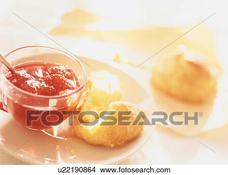 Picture - A muffin and strawberry jam. Fotosearch