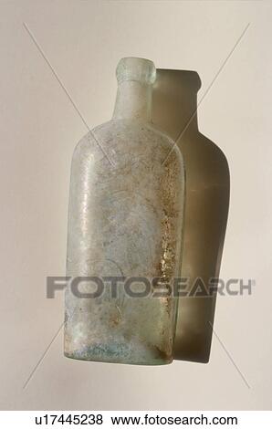 Stock Photo - Aged bottle with shadow on white background. Fotosearch