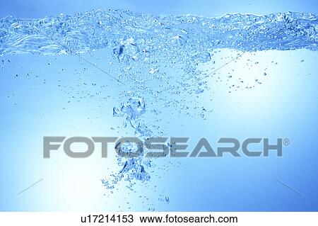 Stock Image - Air bubbles in water, close up, blue background. Fotosearch