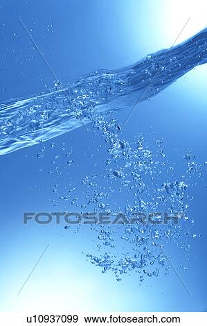 Stock Photo - Air bubbles in water, close up, blue background. Fotosearch