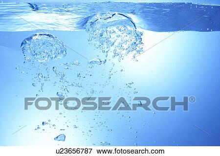 Stock Photo - Air bubbles in water, close up, blue background. Fotosearch