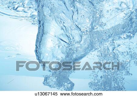 Stock Photography - Air bubbles in water, close up, blue background. Fotosearch