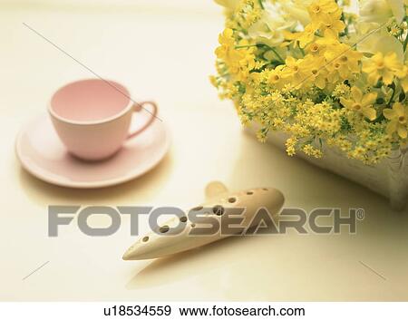 Stock Photo - An ocarina, a tea cup and a flower. Fotosearch