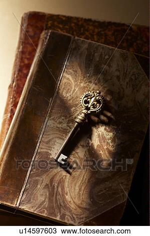 Stock Image - Antique key on books. Fotosearch