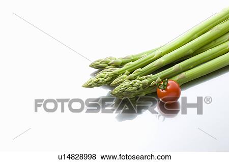 Stock Photo - Asparagus and a cherry tomato. Fotosearch