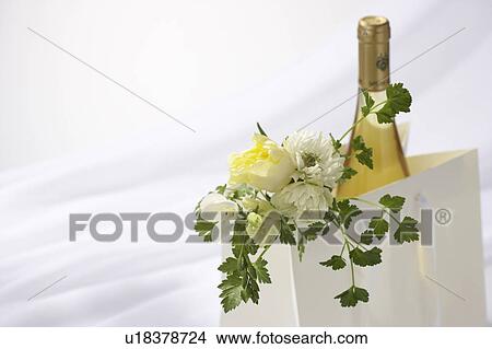 Picture - Bag containing wine and flowers. Fotosearch