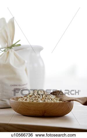 Stock Photograph - Bag of wheat and wooden bowl of mixed grains. Fotosearch