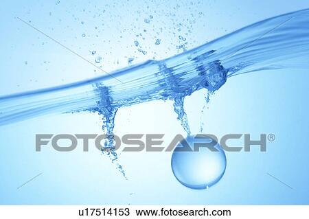 Stock Image - Ball dropped in water, blue background. Fotosearch