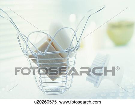 Stock Photography - Bars of soap in a metal basket. Fotosearch