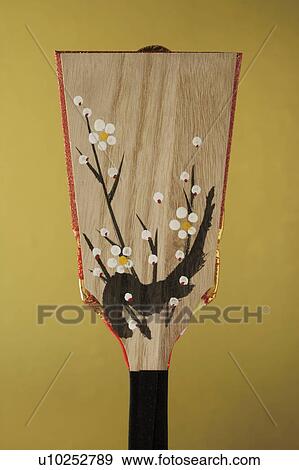 Stock Photo - Battledore decorated with cherry blossom. Fotosearch