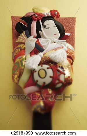 Stock Image - Battledore decorated with Kabuki performer. Fotosearch