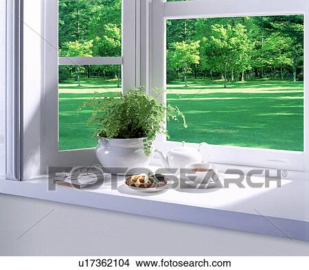 Picture - Bay window with afternoon tea and a potted plant. Fotosearch